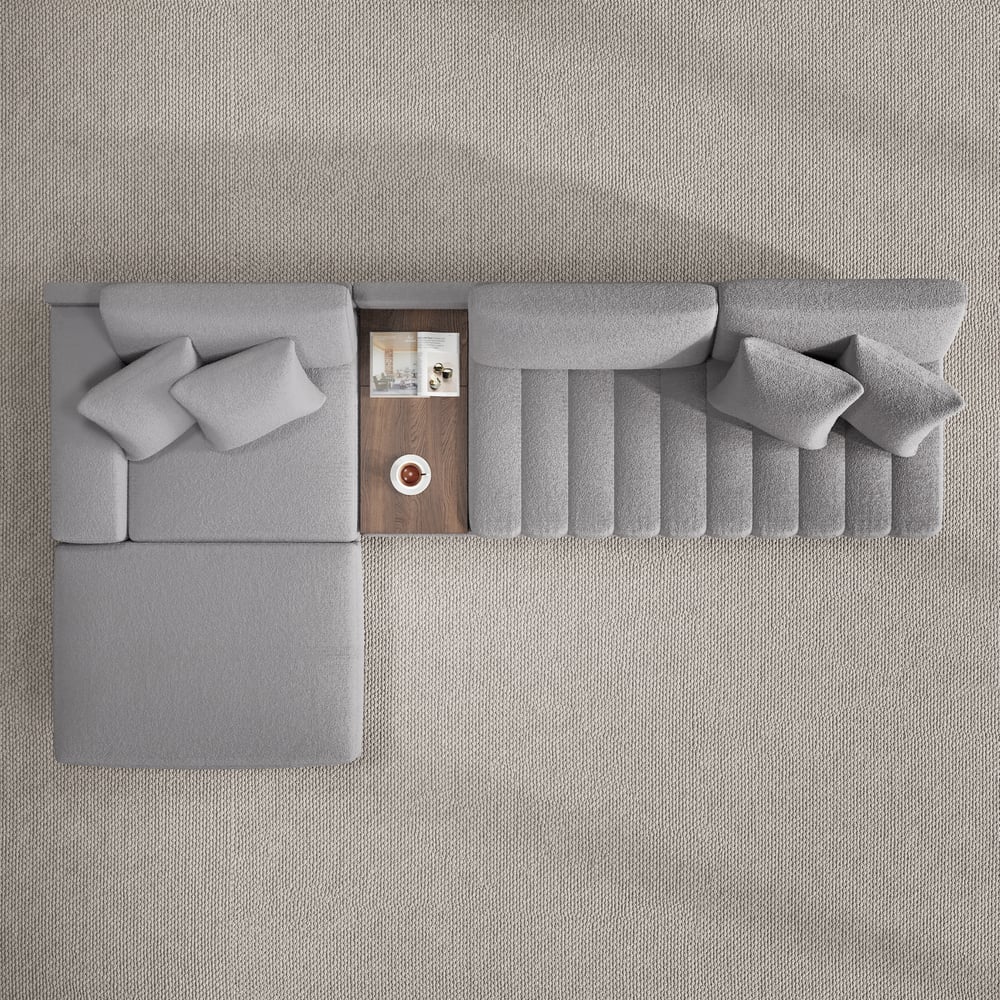 Sofá modular en forma de L Vewal de 320 cm en tela bouclé con chaise longue y otomana Imagen de ventana