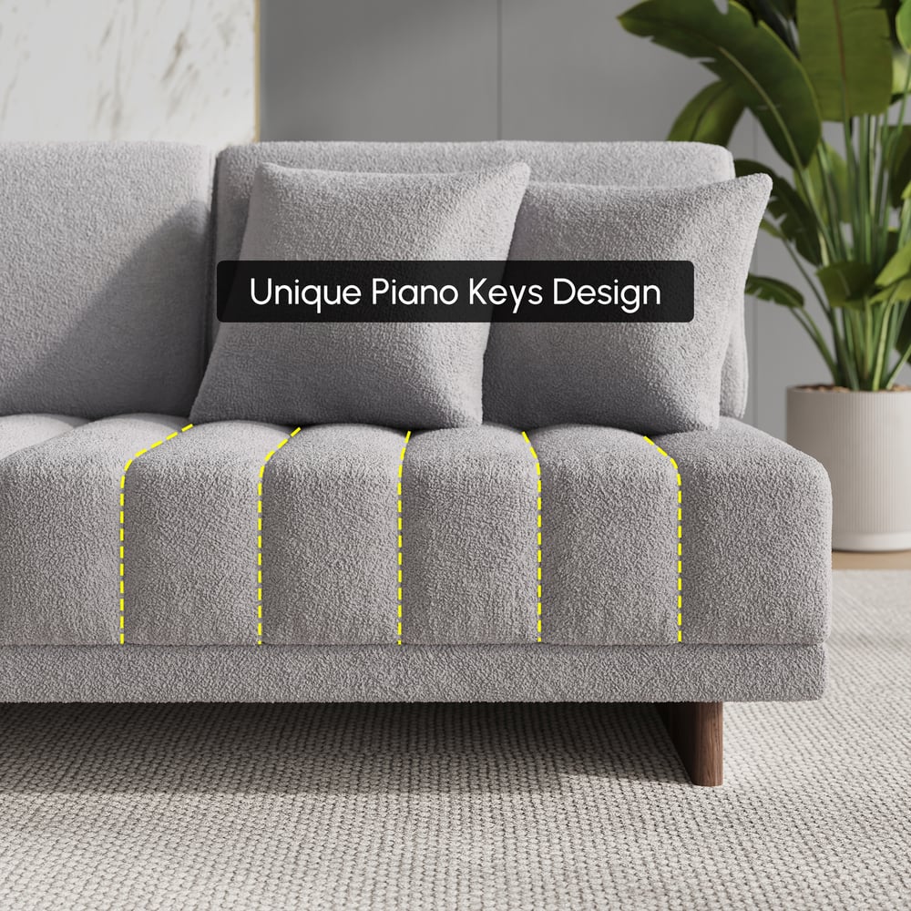 Sofá modular en forma de L Vewal de 320 cm en tela bouclé con chaise longue y otomana Imagen de ventana