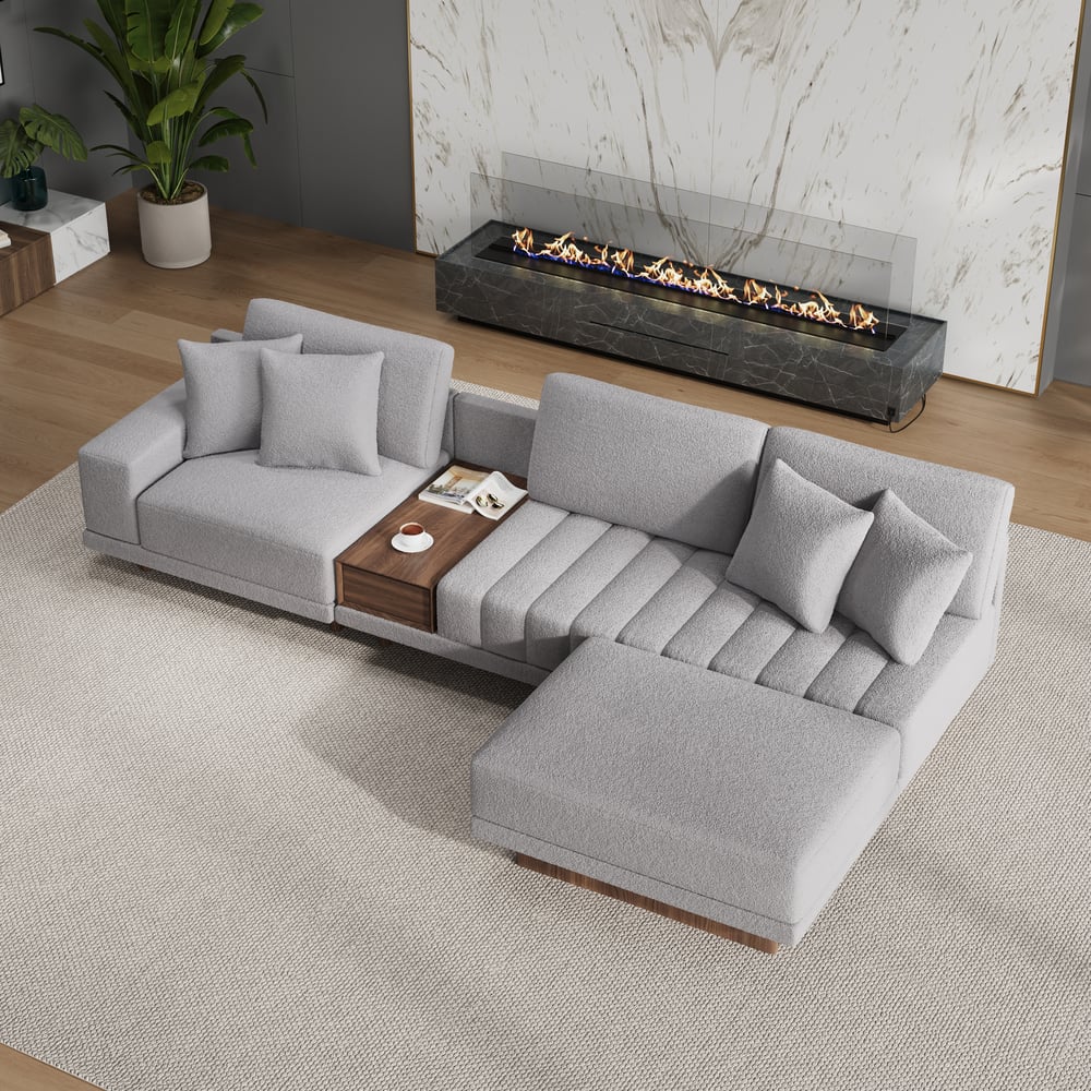 Sofá modular en forma de L Vewal de 320 cm en tela bouclé con chaise longue y otomana Imagen de ventana