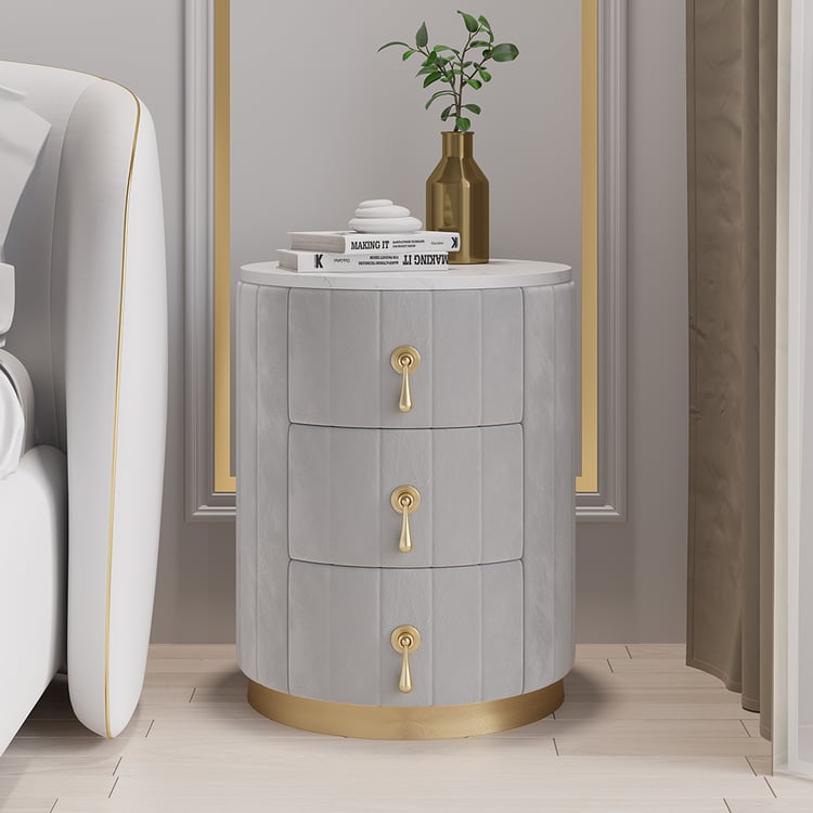 Round gray velvet bedside table with sintered stone top and 3 drawers
