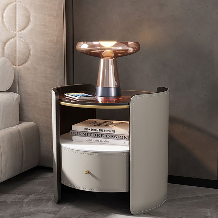 Round bedside table with glass and sintered stone top and a shelf