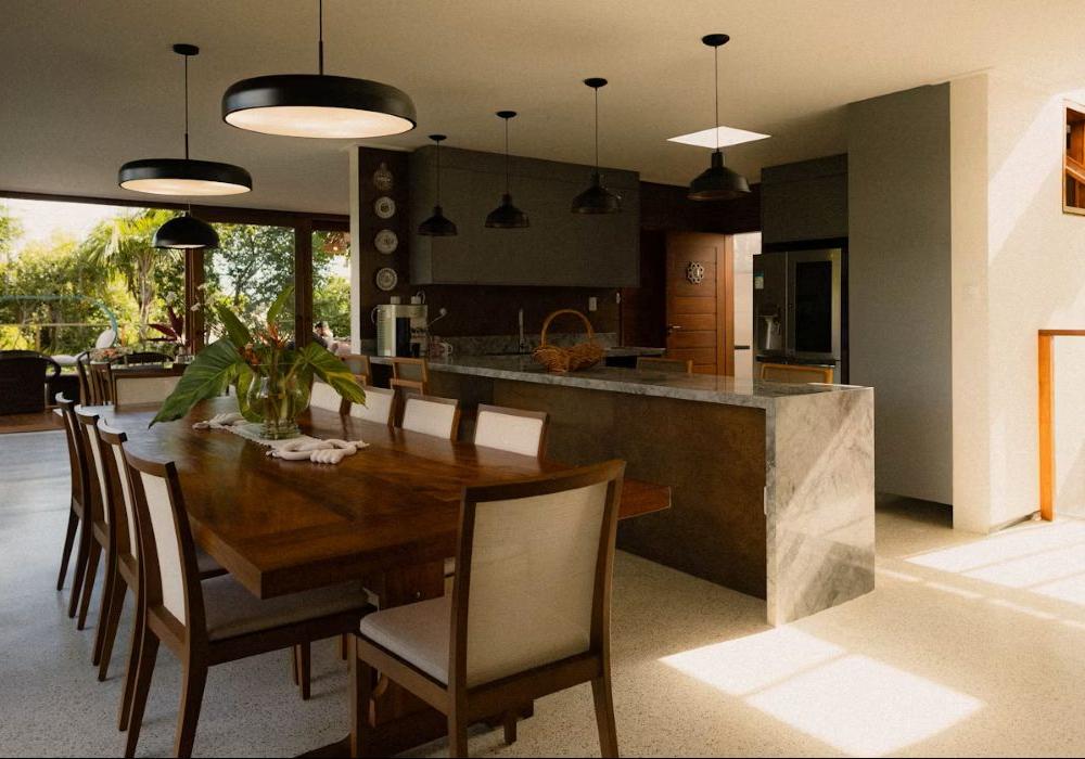 Modern dining room and kitchen with large windows.
