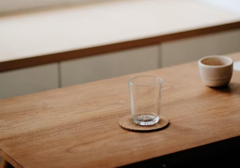 clear drinking glass on brown wooden table