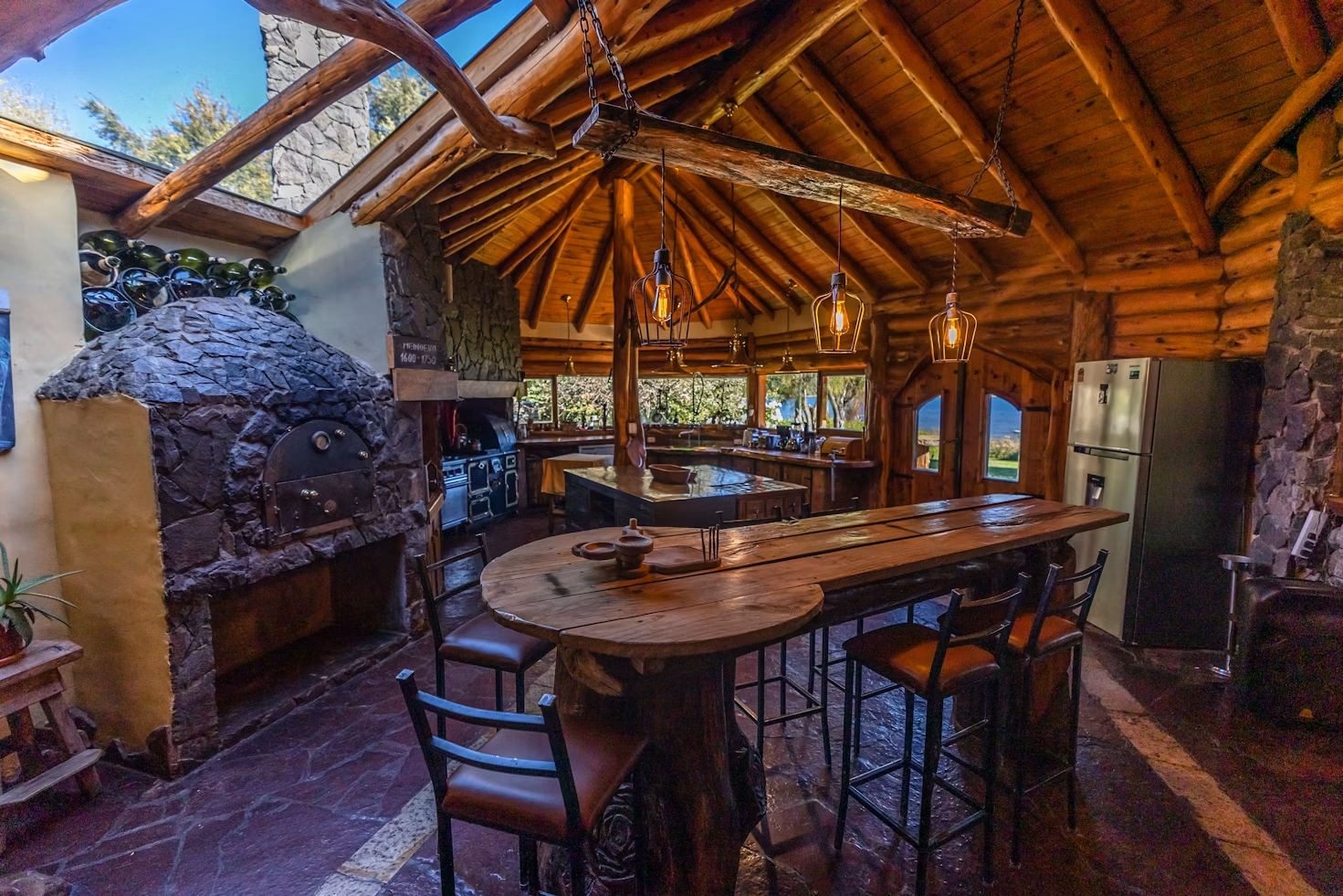a large kitchen with a bar and chairs